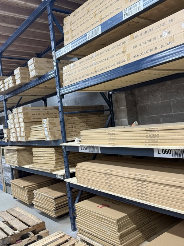 Stacked boxes of laminate flooring planks on warehouse shelving