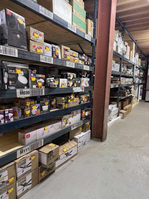 Recessed LED ceiling lights and downlights in retail packaging on warehouse shelving