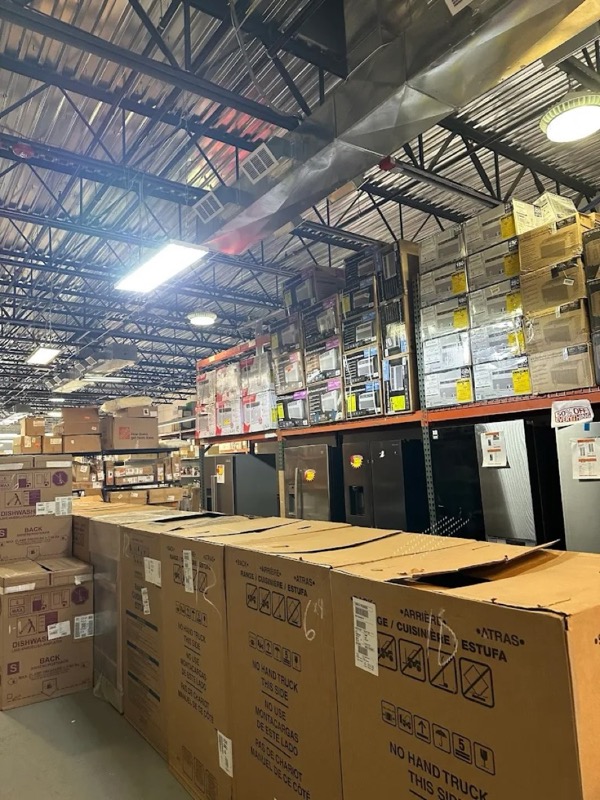 Inside the Miller Place store: aisles of major appliances, dishwasher boxes and overstock home improvement merchandise